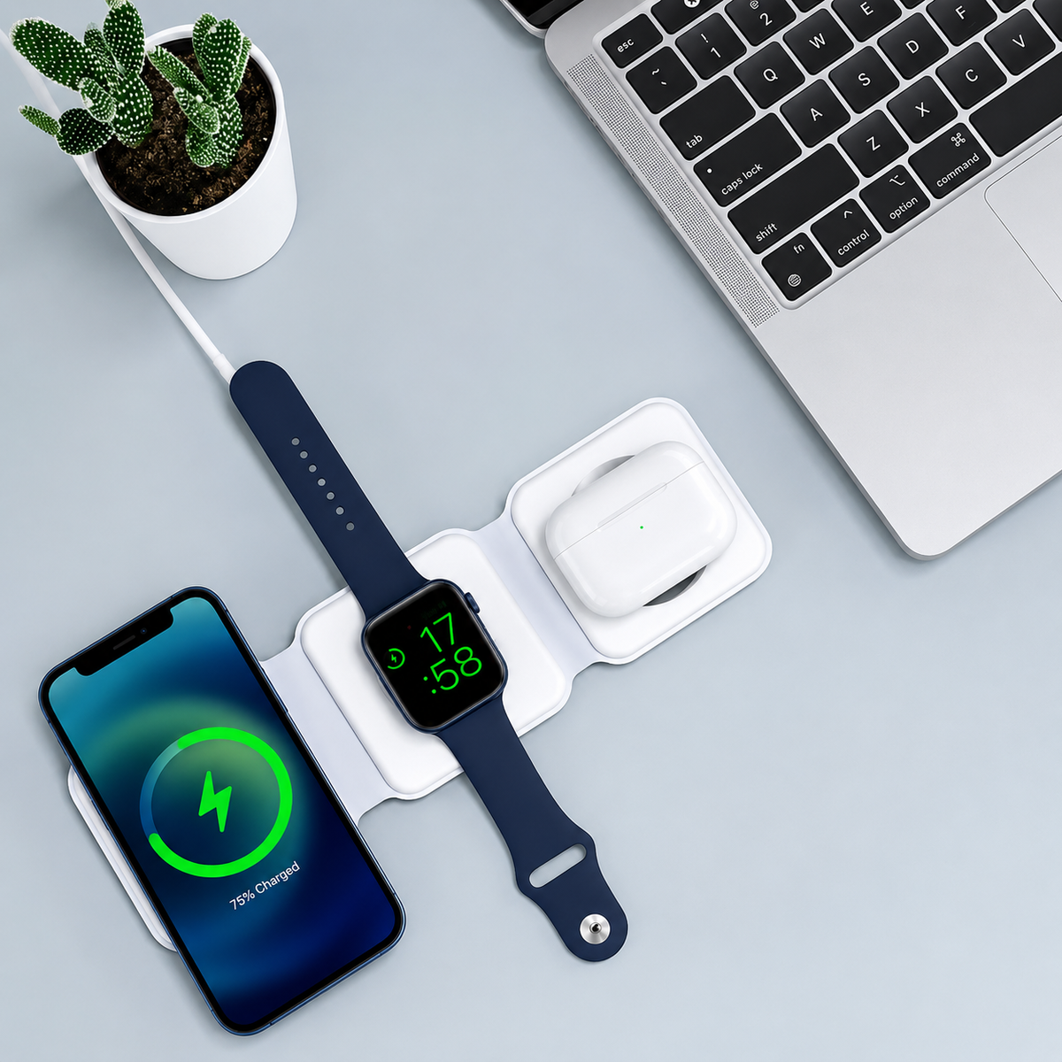White charger charging iPhone, Apple Watch and AirPods on a desk